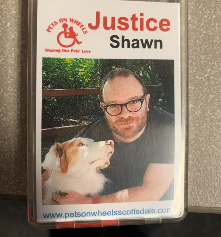A business card for Justice Shawn with a photo of a man and his dog.