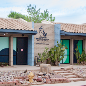 Arizona Animal Welfare League Community Vet Clinic building with a dog logo and desert landscaping.
