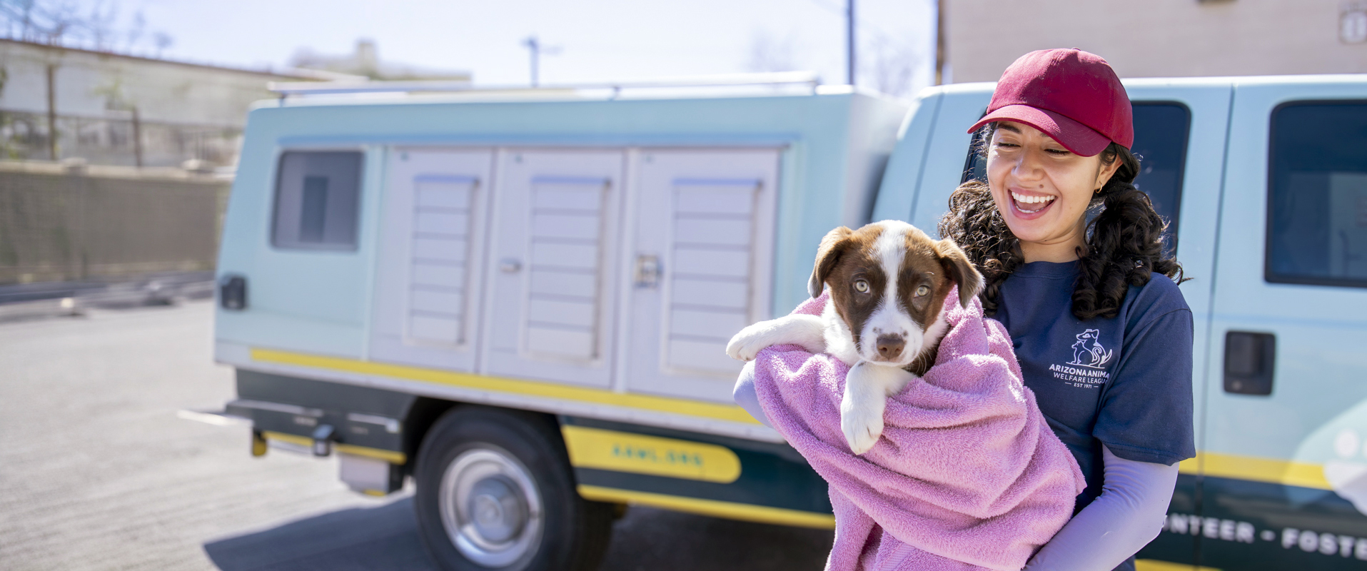 AAWL team members caring for an adoptable dog beside a mobile clinic van